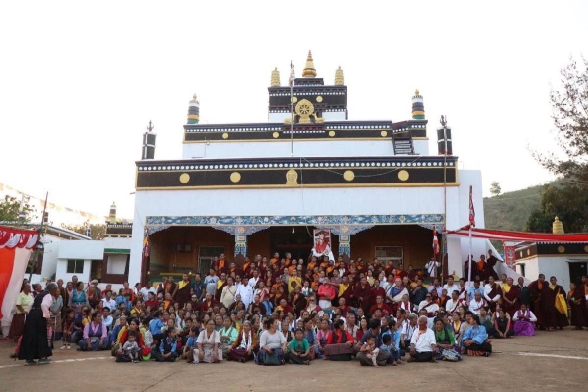 Community group photo in front of the white monastery temple
