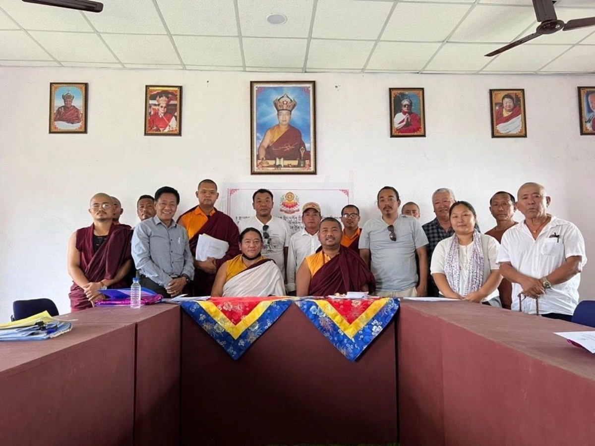 Monks and community members at a planning meeting