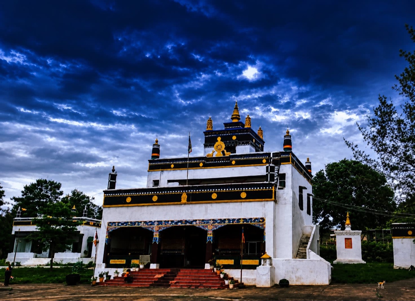 The three-story temple of Dundul Raptenling Monastery under an evening sky